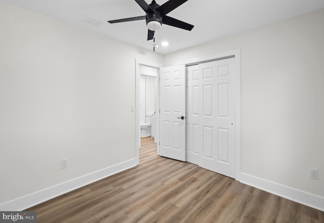 unfurnished bedroom featuring wood finished floors, baseboards, a closet, recessed lighting, and a ceiling fan