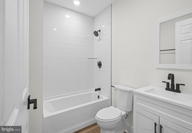 full bath with toilet, vanity,  shower combination, and wood finished floors