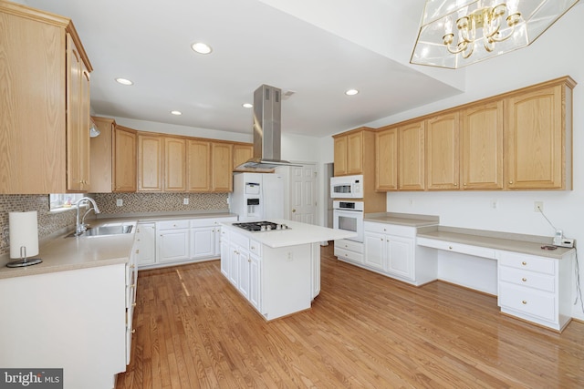 kitchen featuring white appliances, a sink, island exhaust hood, a center island, and tasteful backsplash