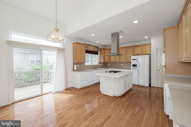 kitchen with white appliances, island exhaust hood, light wood finished floors, light countertops, and tasteful backsplash