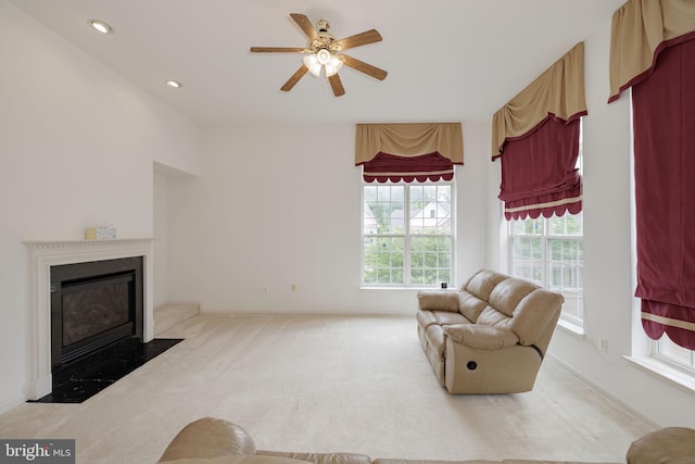 living area featuring a fireplace with flush hearth, carpet, ceiling fan, and recessed lighting