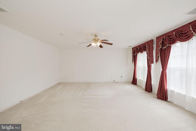 unfurnished room with a ceiling fan and light colored carpet