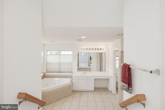 full bathroom with tile patterned floors, a bath, and vanity