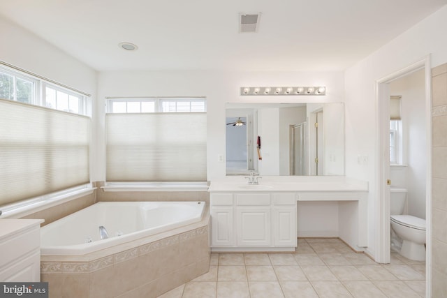 full bathroom with tile patterned floors, a garden tub, vanity, and toilet