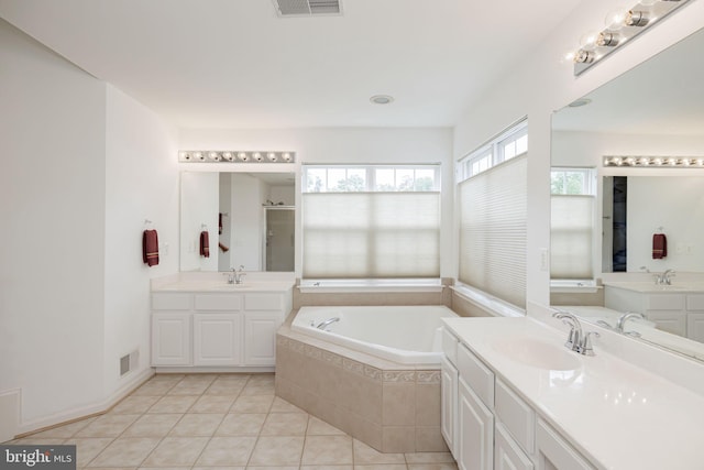 full bathroom featuring a shower stall, a bath, tile patterned flooring, and two vanities