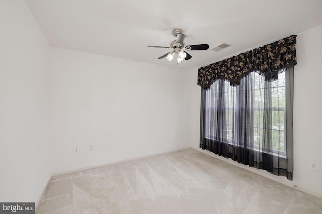 empty room featuring carpet flooring, ceiling fan, and baseboards