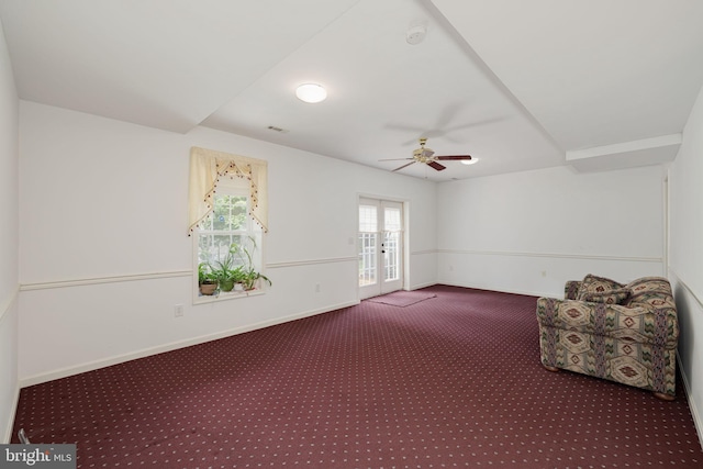 empty room featuring carpet, ceiling fan, french doors, baseboards, and a smoke detector