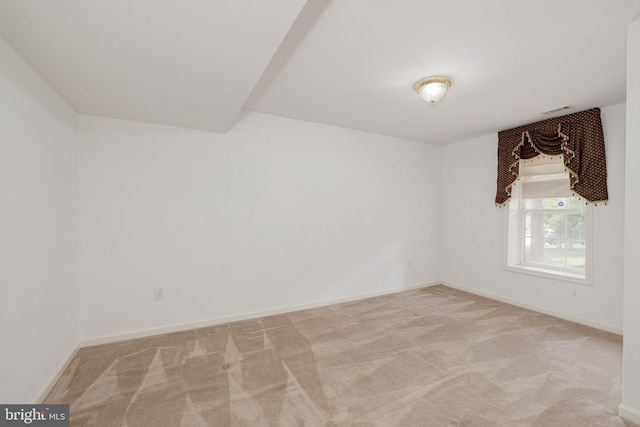 unfurnished room featuring carpet floors and baseboards