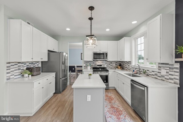 220 Ladysmith Dr, Stephens City, VA 22655 - kitchen with stainless steel appliances, a kitchen island, light wood-type flooring, backsplash, and recessed lighting