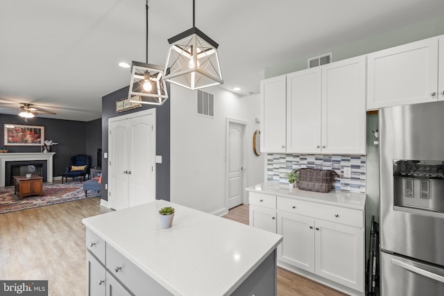 220 Ladysmith Dr, Stephens City, VA 22655 - kitchen featuring stainless steel fridge, light countertops, open floor plan, decorative backsplash, and a ceiling fan