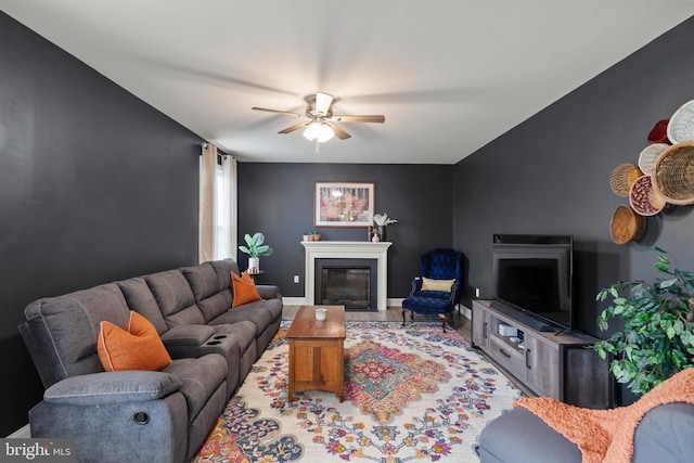 220 Ladysmith Dr, Stephens City, VA 22655 - living room with a glass covered fireplace, a ceiling fan, and baseboards