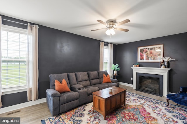 220 Ladysmith Dr, Stephens City, VA 22655 - living room featuring wood finished floors, ceiling fan, a fireplace with flush hearth, and baseboards