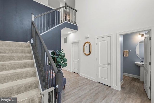 220 Ladysmith Dr, Stephens City, VA 22655 - entryway with wood finished floors, a towering ceiling, baseboards, and stairs