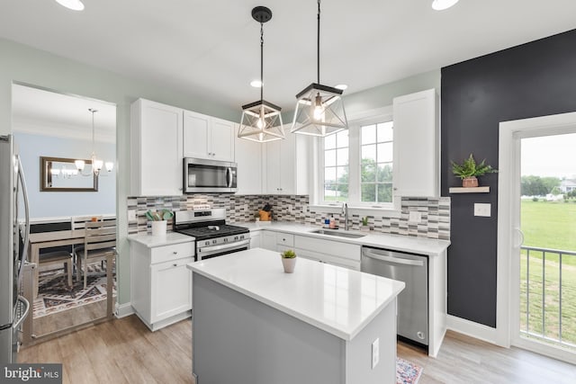 220 Ladysmith Dr, Stephens City, VA 22655 - kitchen with appliances with stainless steel finishes, a sink, a chandelier, light countertops, and backsplash