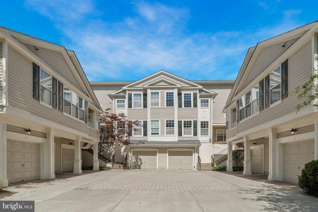 townhome / multi-family property featuring an attached garage and driveway