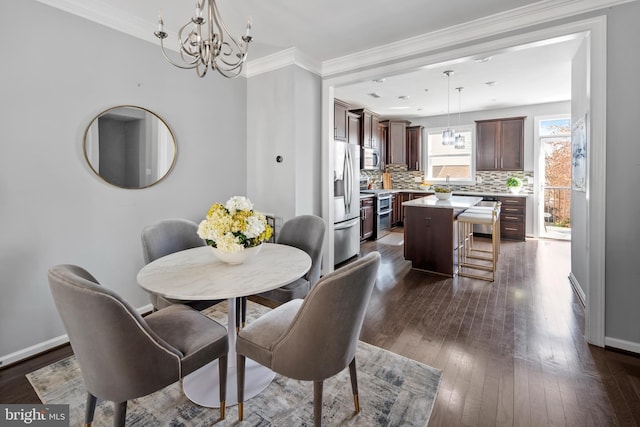 dining space featuring a chandelier, dark wood-style flooring, baseboards, and crown molding