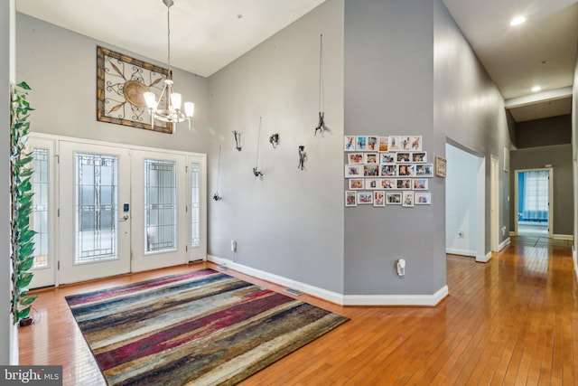 13716 Molly Berry Rd, Brandywine, MD 20613 - entryway with high vaulted ceiling, a chandelier, hardwood / wood-style floors, baseboards, and french doors