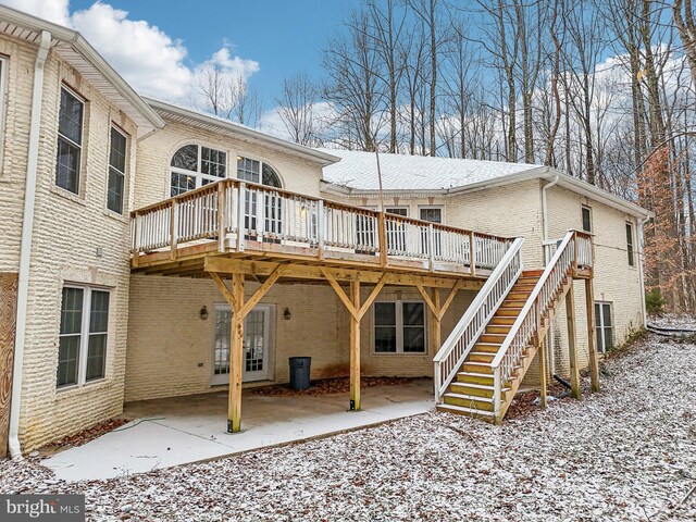 13716 Molly Berry Rd, Brandywine, MD 20613 - snow covered property with brick siding, a deck, and a patio area