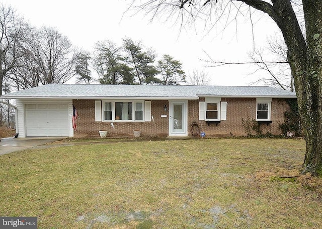 ranch-style house featuring an attached garage, brick siding, a front lawn, and driveway