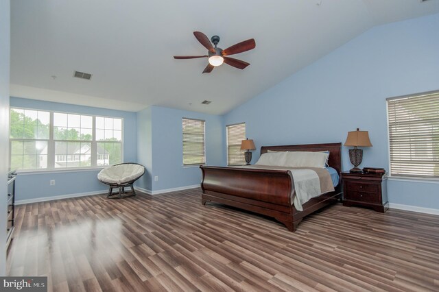 bedroom with wood finished floors, multiple windows, baseboards, a ceiling fan, and high vaulted ceiling