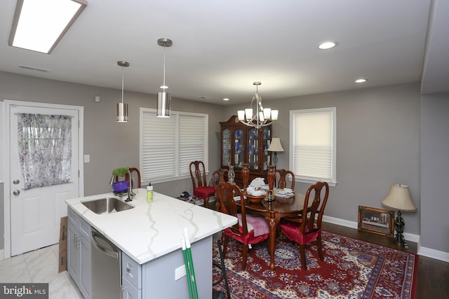 kitchen featuring a sink, stainless steel dishwasher, recessed lighting, gray cabinets, and baseboards