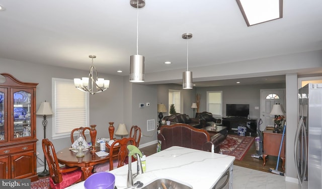 dining space featuring recessed lighting, a chandelier, and baseboards