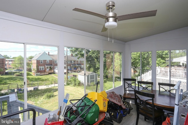 sunroom featuring ceiling fan, healthy amount of natural light, and lofted ceiling