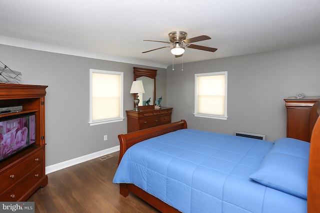 bedroom featuring dark wood-style floors, baseboards, and a ceiling fan