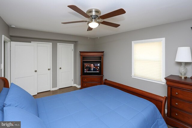 bedroom with wood finished floors, baseboards, and ceiling fan