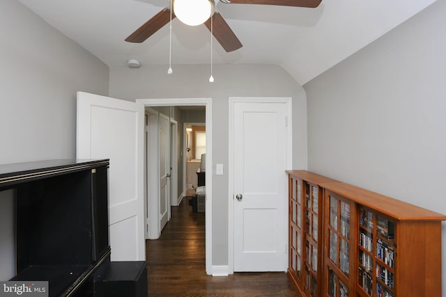 hall with wood finished floors and vaulted ceiling