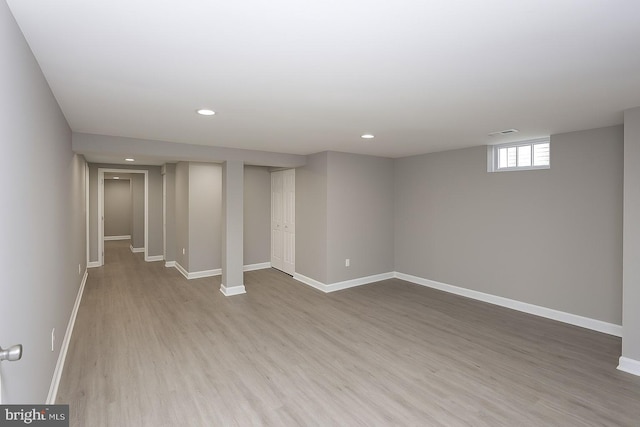 below grade area featuring wood finished floors, baseboards, and recessed lighting