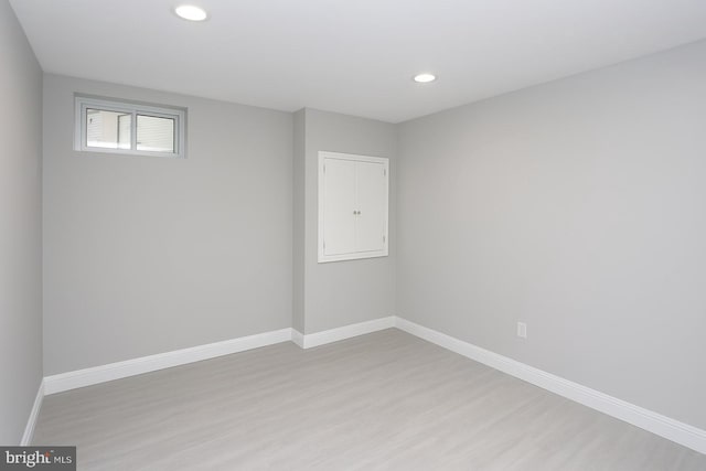 unfurnished room with light wood-style flooring, baseboards, and recessed lighting
