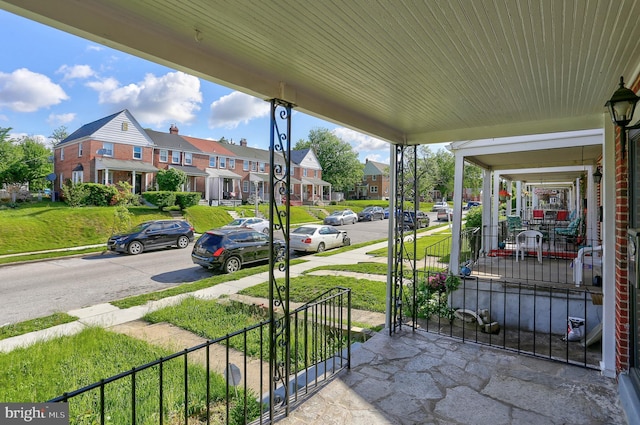 view of patio featuring a residential view and a porch