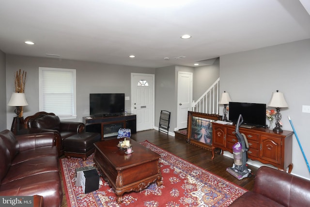 living area featuring wood finished floors, stairway, and recessed lighting