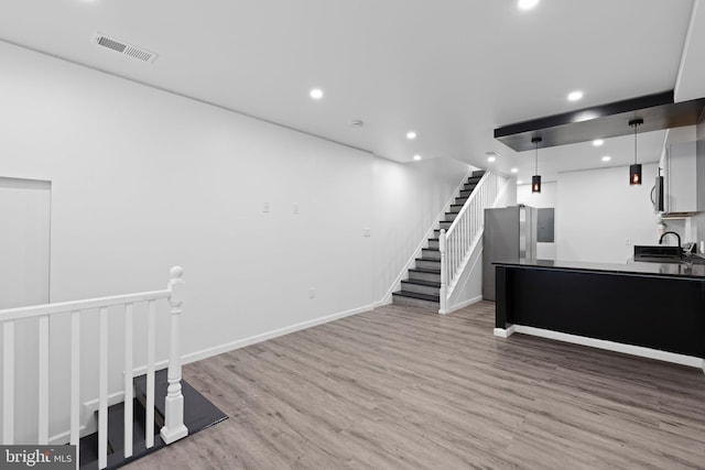 2118 Wilkens Ave, Baltimore, MD 21223 - unfurnished living room with wood finished floors, recessed lighting, and baseboards