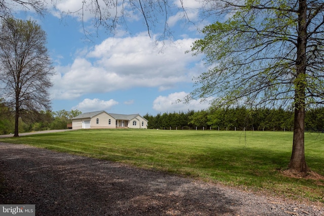 11490 Tilia Ln, Bealeton, VA 22712 - view of green lawn with an attached garage and a view of trees