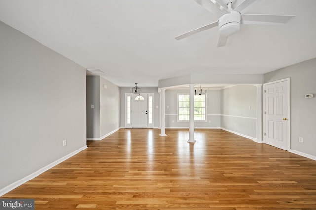 11490 Tilia Ln, Bealeton, VA 22712 - unfurnished living room featuring light wood-style flooring, baseboards, a chandelier, and a ceiling fan