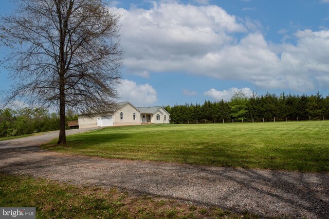 11490 Tilia Ln, Bealeton, VA 22712 - view of green lawn featuring driveway, a view of trees, and an attached garage