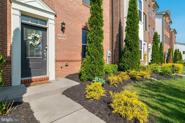doorway to property with brick siding