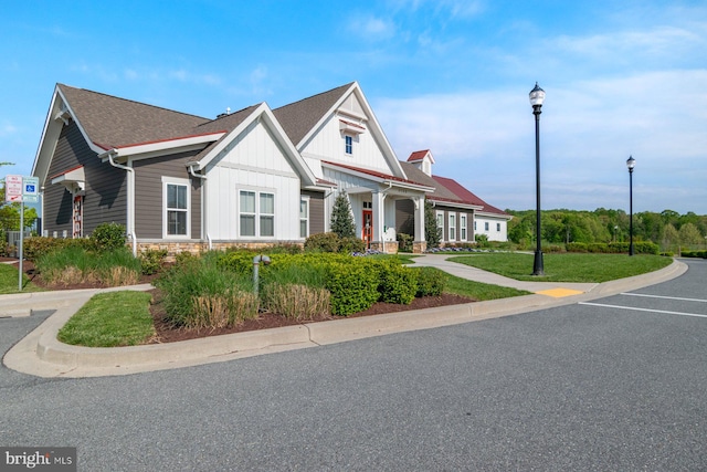 view of front of property with board and batten siding and stone siding
