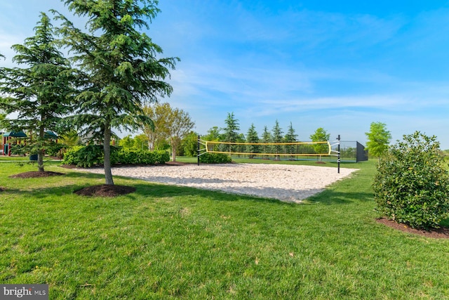 view of home's community with volleyball court and a lawn