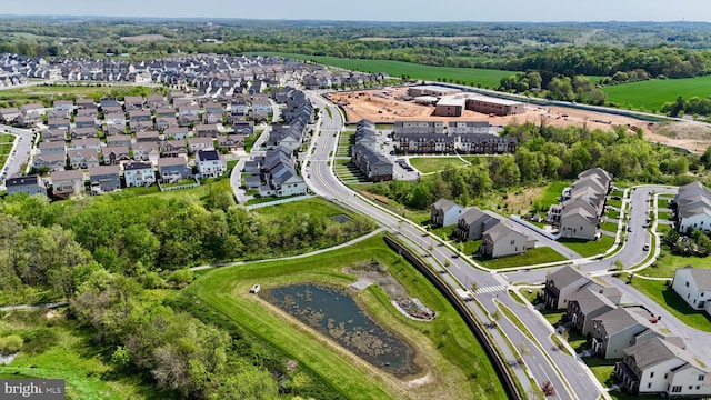 aerial view of property's location with nearby suburban area and a nearby body of water