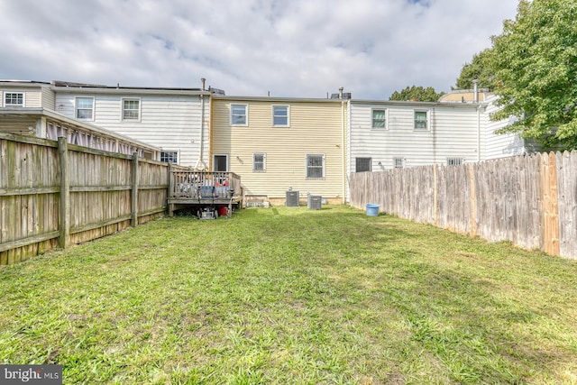 back of house featuring central air condition unit and a deck