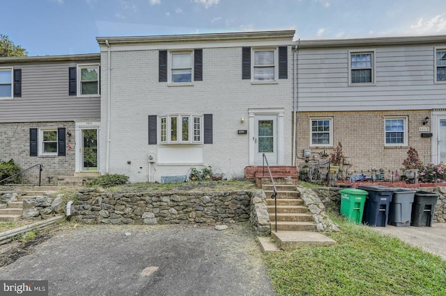 view of property with brick siding and entry steps