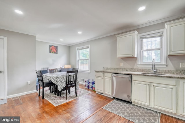 kitchen featuring dishwasher, a sink, light wood-type flooring, white cabinets, and ornamental molding