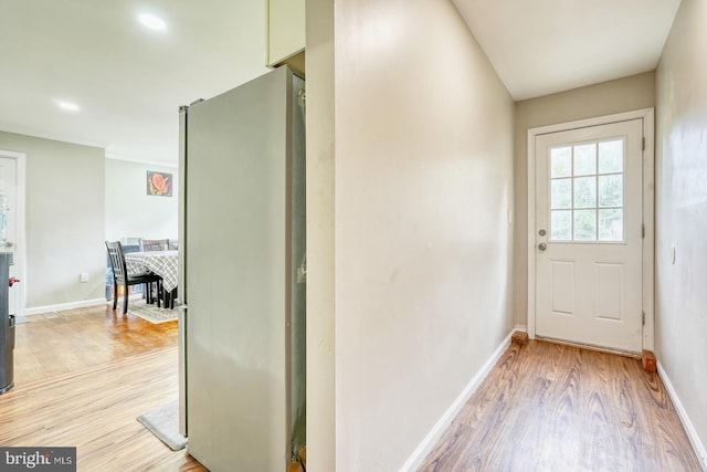 entryway with light wood-type flooring and baseboards