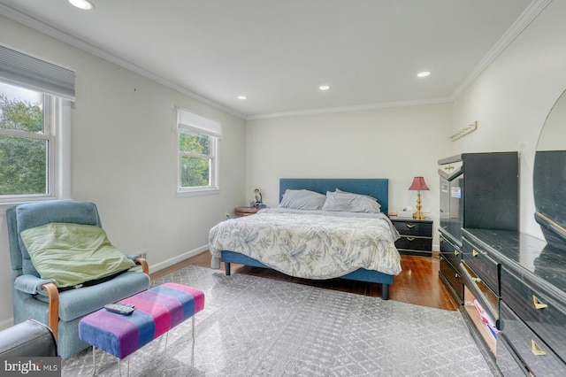 bedroom featuring wood finished floors, ornamental molding, recessed lighting, and baseboards