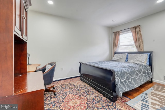 bedroom with recessed lighting, baseboards, and wood finished floors