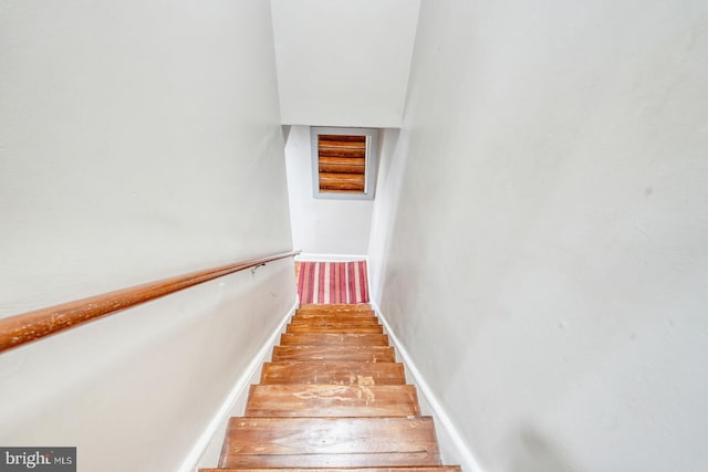 stairway featuring wood finished floors and baseboards