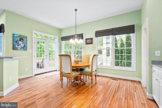 3747 Spicebush Dr, Frederick, MD 21704 - dining room with a chandelier, baseboards, light wood-type flooring, and plenty of natural light